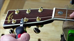 Feed the string through the tuning post and cut off the excess at the next one