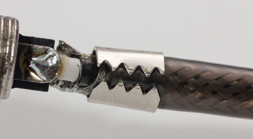 Here, the "jaws" are bent around the cable to hold it securely in place.